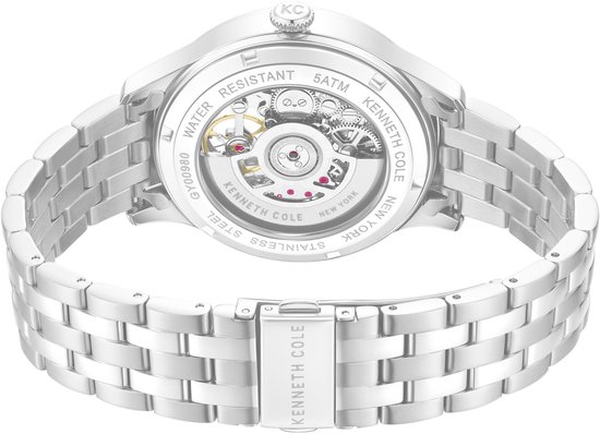 Achterkant van een zilverkleurig horloge met zichtbaar automatisch uurwerk.