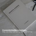 Crèmekleurig 'Growth Journal' met de tekst '6 overzichtelijke modules'.