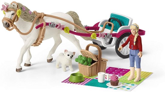 Wit paard, blonde amazone, hondje en picknickspullen op een kleed.