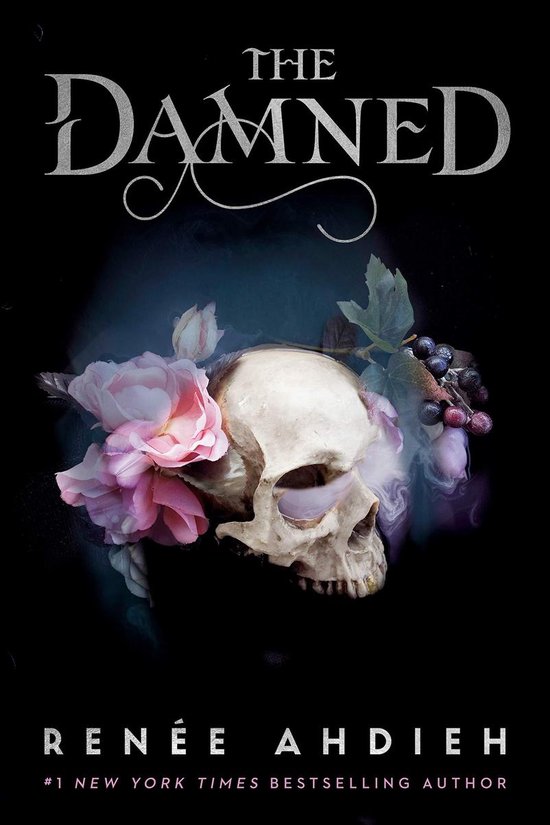 Boek 'The Damned' met een schedel versierd met roze rozen en donkere bessen.