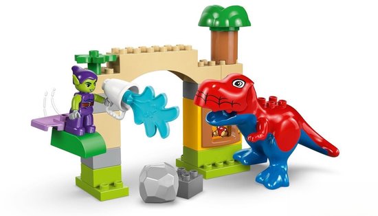 Rode en blauwe T-Rex met groene goblin op paars platform met water.