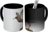 Magische Mok - Foto op Warmte Mok - Een tureluur stijgt op vanaf een paal - 350 ML
