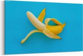 Schilderij - Opened banana on bright blue paper — 90x60 cm