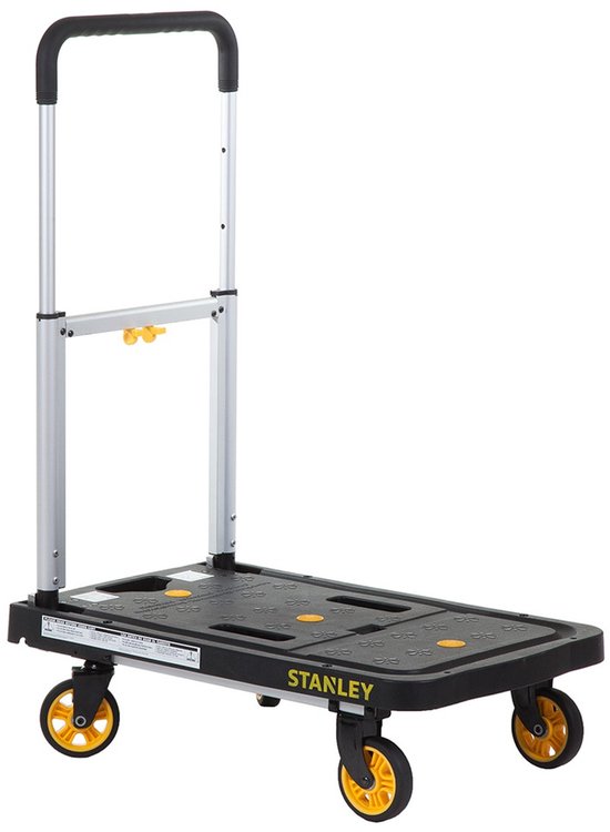 Stanley platformwagen met zilverkleurig, inklapbaar handvat en gele wielen. Het zwarte platform heeft gele antislip noppen en het "STANLEY" logo.