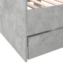 Betongrijze slaapbank, close-up van de hoek met een lade.