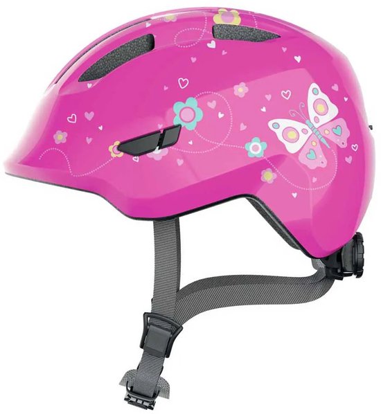 Roze fietshelm voor kinderen met vlinder- en bloemenprint. Grijs verstelbare bandjes.