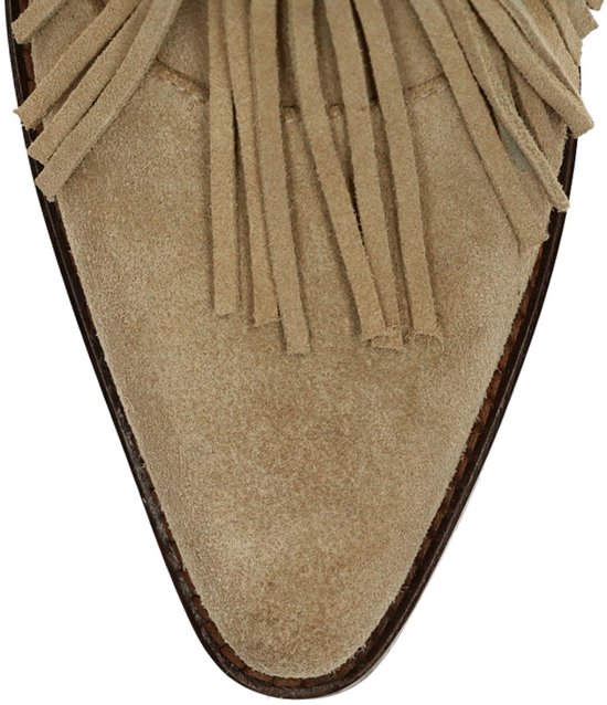 Puntige neus van beige suède laars met franjes.