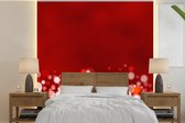 Behang - Fotobehang Rode glitters bij een onscherpe achtergrond - Breedte 350 cm x hoogte 350 cm