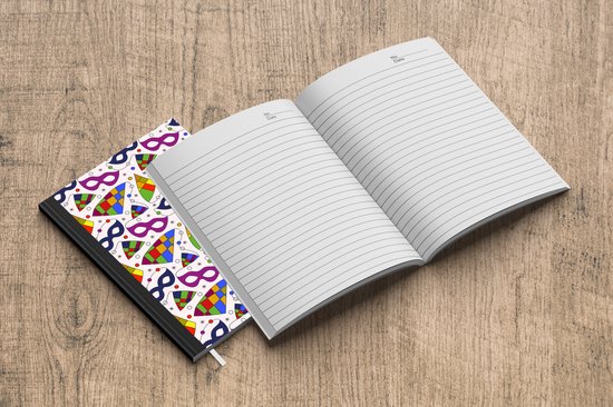 Carnet blanc à motifs de carnaval et carnet vierge ouvert à côté, sur fond de bois.