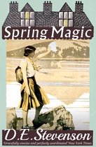 Boekomslag van 'Spring Magic' door D.E. Stevenson. Een vrouw met rugzak staat op een rots en reikt naar de zon.