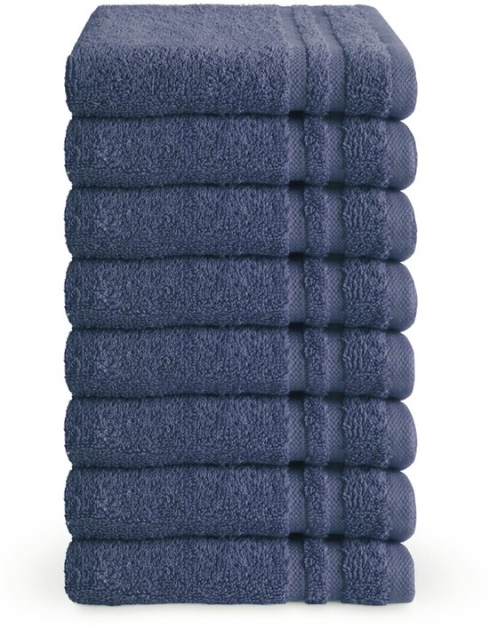 Stapel van acht donkerblauwe gastendoekjes, gevouwen met subtiele horizontale strepen aan de zoom.