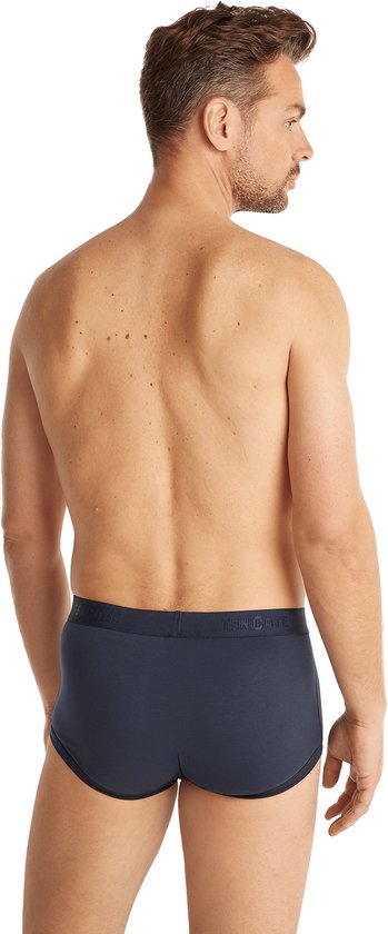 Man, staand, de rug zichtbaar, met donkerblauwe slip, logo op tailleband.