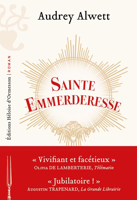 Boek 'Sainte Emmerderesse' van Audrey Alwett, met een centrale cirkel van stralen en tekst in rode en gouden letters.