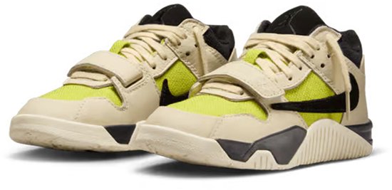 Kindersneakers in crèmekleur met felgroene panelen, zwarte swoosh en klittenbandsluitingen.