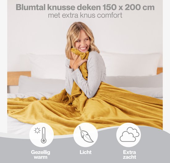 Vrouw omhelst gele plaid, met icoontjes.