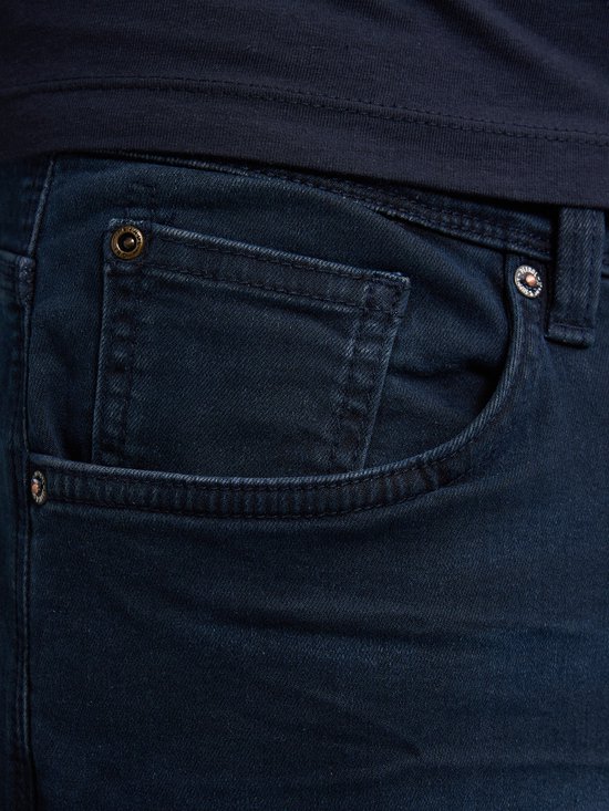 Detail van de voorzak van een donkerblauwe jeans.