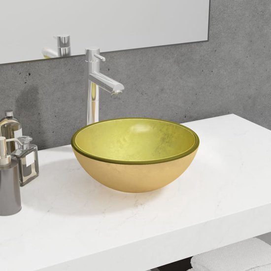 Lavabo doré avec un bord brun foncé.