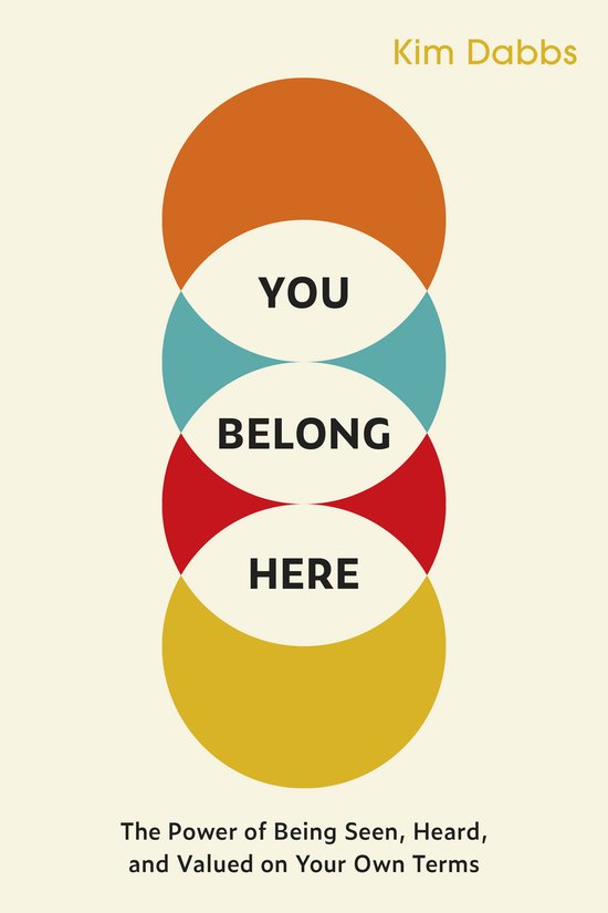 Boekomslag met "YOU BELONG HERE" in zwarte letters op een crèmekleurige achtergrond, met gestapelde oranje, cyaan en rode cirkels. Kim Dabbs
