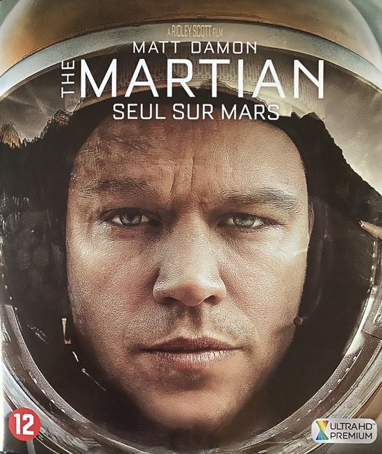 Matt Damon als astronaut in de film 'The Martian'. De close-up toont zijn gezicht in een helm, met de titel van de film.