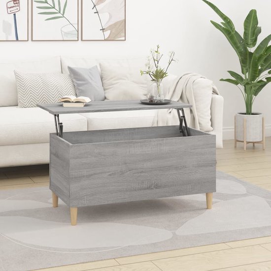 Grijze salontafel met houtnerf en opklapbaar blad, op houten pootjes, in woonkamer.