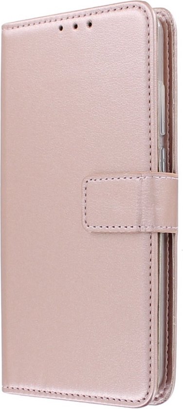 Étui portefeuille rose doré fermé, face au spectateur.