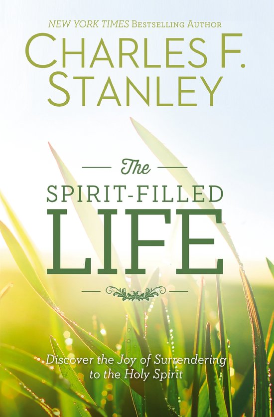 Boekcover: The Spirit-Filled Life door Charles F. Stanley. Groene tekst op achtergrond van gras en zonlicht.
