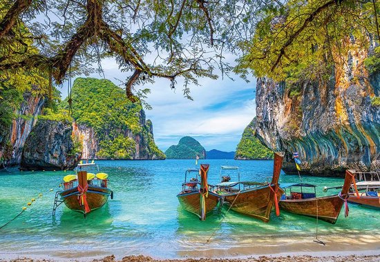 Puzzel van een tropische baai in Thailand, met houten boten op het heldere turquoise water en weelderige rotsformaties.