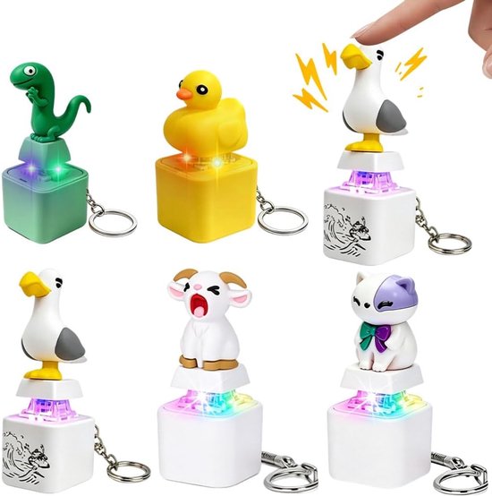 Vijf verschillende speelgoed-sleutelhangers met figuren van een dinosaurus, eend, meeuw, geit en kat met ledverlichting.