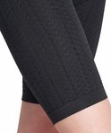 Close-up van de zwarte, ondoorzichtige stof met een gestructureerd patroon van de corrigerende legging.