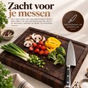 Walnoothouten snijplank met gesneden groenten en een mes; mesvriendelijk oppervlak.