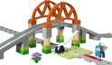 Duplo treinbrug met oranje bogen, grijze rails, seinhuis en bouwfiguur.