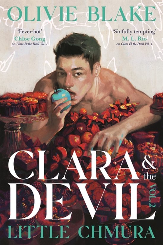 Boekomslag Clara & the Devil Vol. 2: een man met ontbloot bovenlijf eet een appel tussen rode vruchten en desserts.