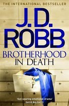 Boek "Brotherhood in Death" van J.D. Robb. Een kluis met een blauw kledingstuk en sleutel. Internationale bestseller.