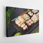 Canvas schilderij - Set of sushi rolls with wasabi and ginger on a black background. Japanese oriental cuisine  -     1667685301 - 50*40 Horizontal