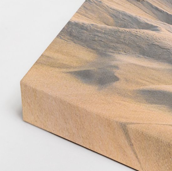 Detail van de zijkant van een canvasprint met zandduinen.