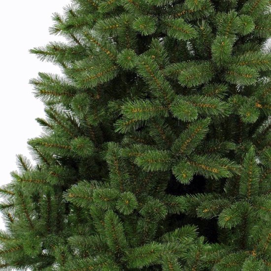 Gedetailleerde close-up van de volle groene takken van een kunstkerstboom.