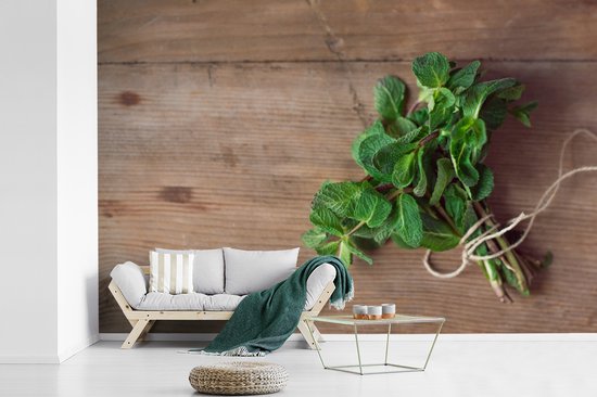 Papier peint photo en vinyle - Feuilles de menthe fraîche sur une table en bois largeur 330 cm x hauteur 220 cm - Tirage photo sur papier peint (disponible en 7 tailles)