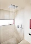 Ingebouwde vierkante douchekop met water dat naar beneden stroomt in een moderne badkamer.