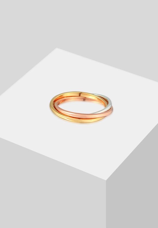 Dri COLORS ring van goud, zilver en roségoud, gepresenteerd op een witte kubus.