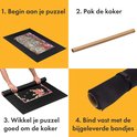Stappenplan voor het gebruik van de puzzelmat: 1. Begin aan je puzzel, 2. Pak de koker, 3. Wikkel je puzzel goed om de koker, 4. Bind vast met de bijgeleverde bandjes.