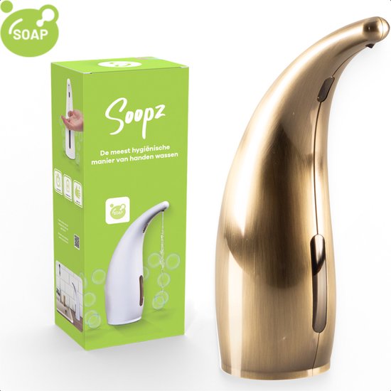 Gouden automatische zeepdispenser naast de groene verpakking.