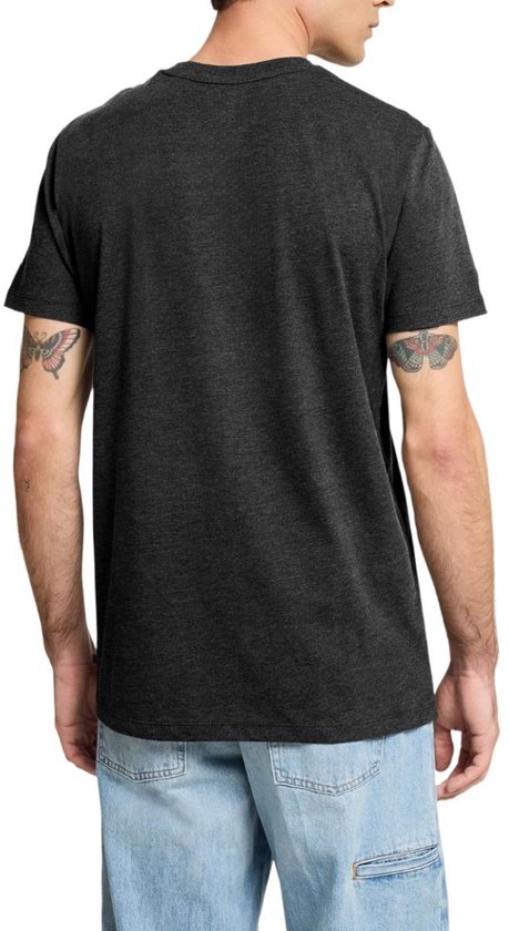 Man met tatoeages op de bovenarmen, draagt een donkergrijs T-shirt.