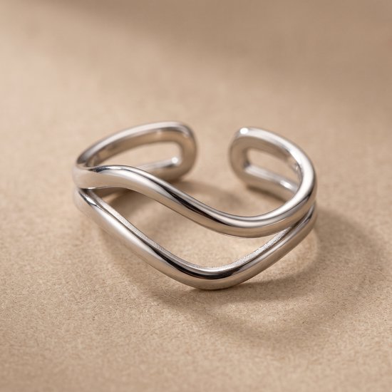 Une bague ouverte minimaliste argentée avec un design à double fil ondulé.