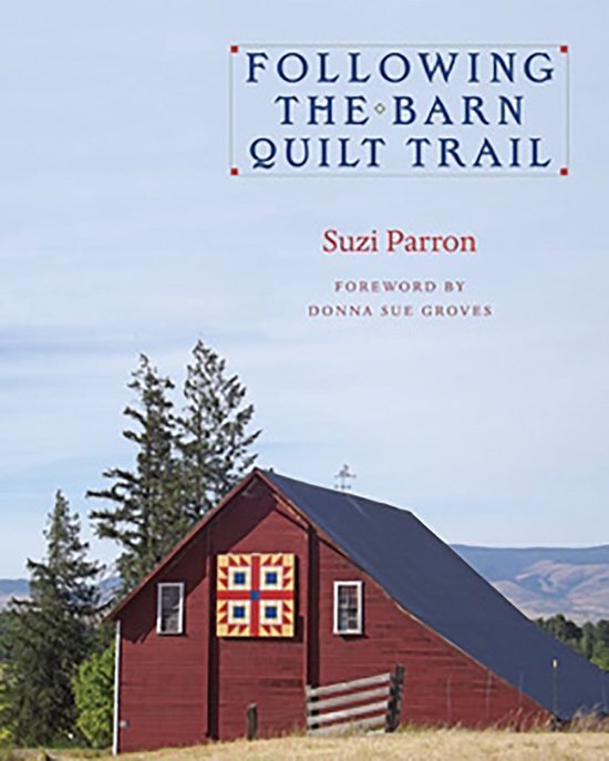 Livre "Following the Barn Quilt Trail" avec une grange rouge ornée d'une courtepointe de grange aux losanges bleus et jaunes sur la couverture.