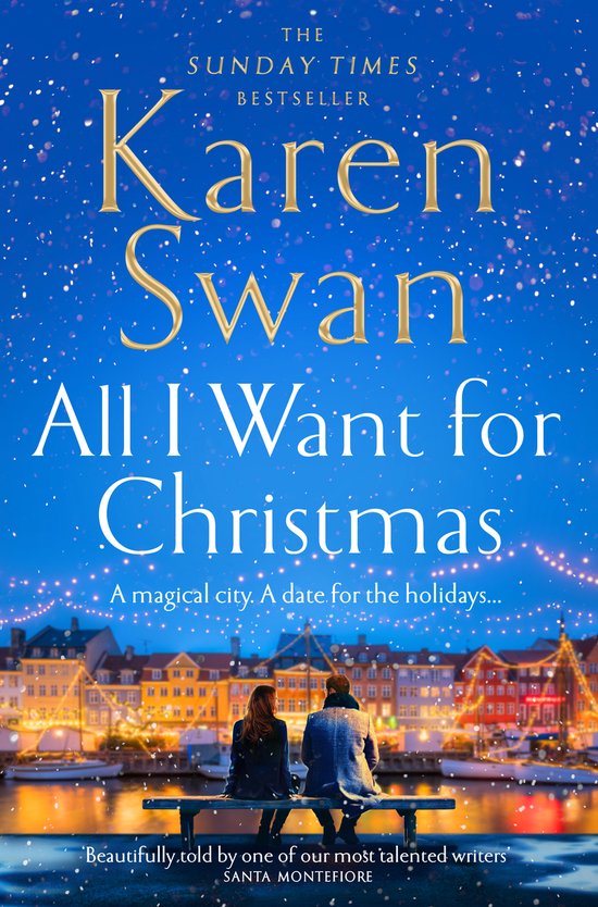 Boekcover van "All I Want for Christmas" van Karen Swan, met een stel zittend op een bankje met uitzicht op een kerstig verlichte stad.