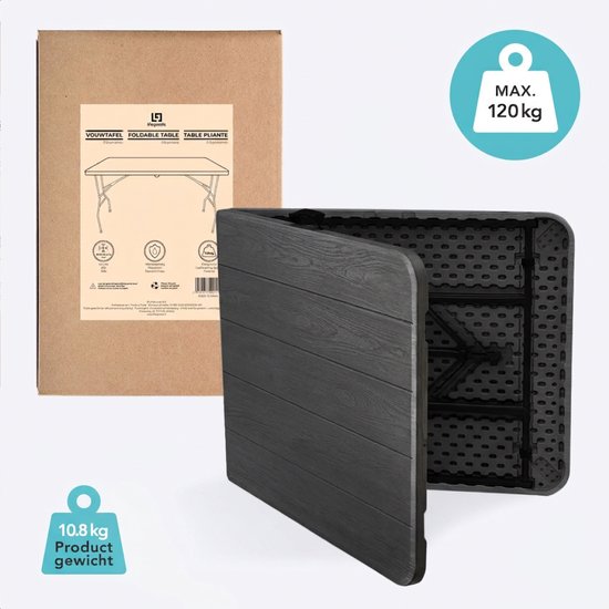 Grijze, inklapbare tafel in gesloten toestand, naast de verpakking. Gewicht 10,8 kg.