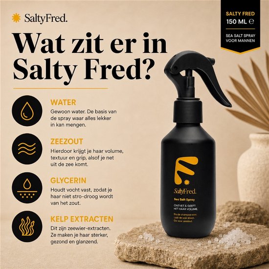 Zwarte spuitfles SaltyFred Sea Salt Spray op steen, met tekst over de ingrediënten: water, zeezout, glycerine en kelp extracten.