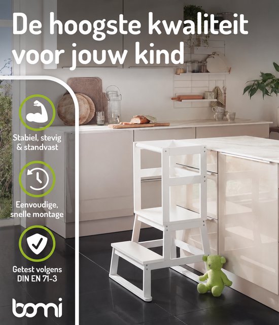 Witte BOMI leertoren in een lichte keuken, met een groene teddybeer op de vloer. Met "Stabiel, stevig & standvast".