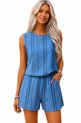 Blauwe zomerse playsuit met verticale streepjes en elastische tailleband. Model draagt sieraden.