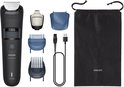 Zwarte Philips baardtrimmer met accessoires: 2 trimkammen, precisietrimmer, USB-kabel, opvangbakje en opbergzakje.